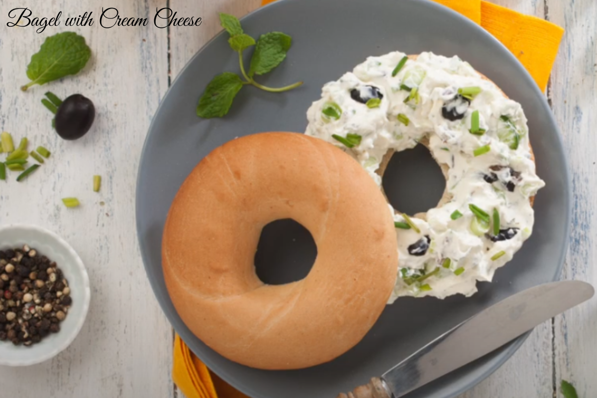 Freshly toasted bagel with cream cheese topped with smoked salmon and dill.