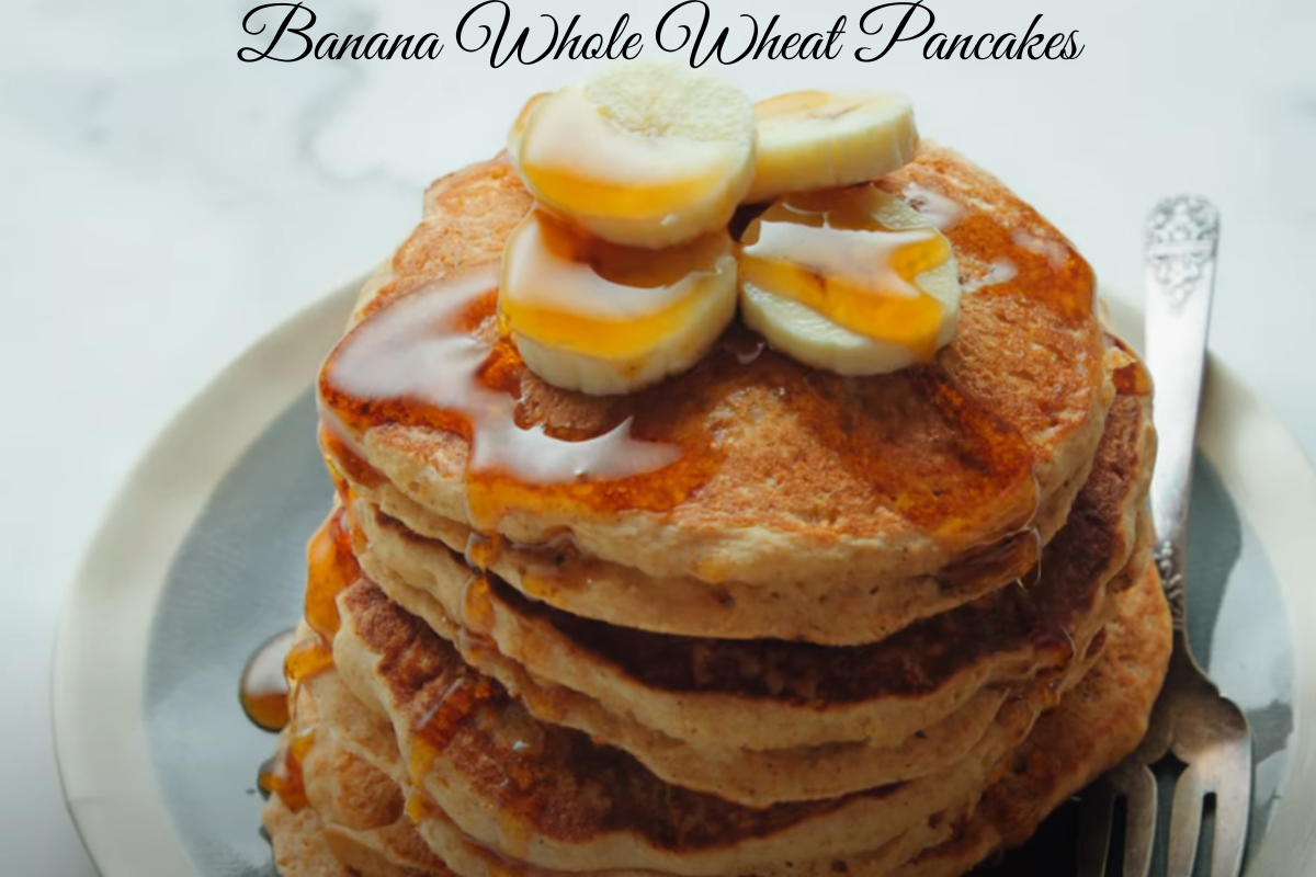 Banana Whole Wheat Pancakes topped with sugar-free maple syrup and fresh berries.