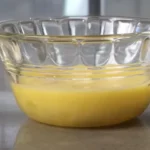 Eggs in a bowl with whisk and flour, showcasing their essential role in cooking and baking recipes.