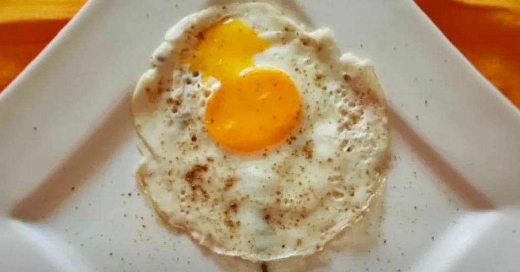What Questions Can You Ask About Eggs? 2 A chef cracking an egg into a bowl with ingredients for a recipe, highlighting the versatility of eggs in cooking and baking.