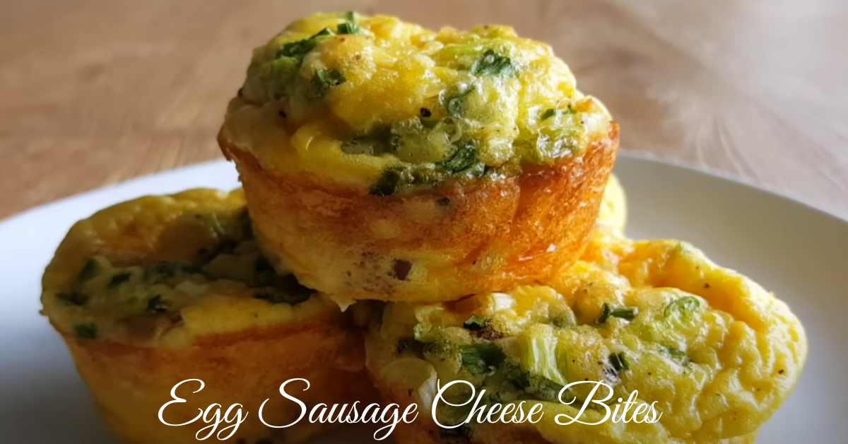 A close-up image of freshly baked Egg Sausage Cheese Bites in a muffin tin, showcasing their golden, cheesy texture.