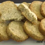 Freshly baked Earl Grey cookies on a white plate, infused with aromatic tea flavors and garnished with a touch of lemon zest.